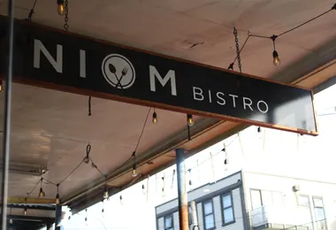 Niom Bistro street sign on Riddiford Street, Newtown, Wellington