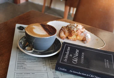 Flat white coffee and almond croissant at Niom Bistro, Newtown