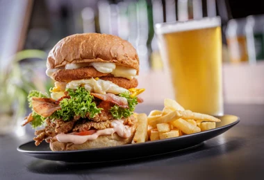 Buttermilk fried chicken burger with fries and beer at Niom Bistro