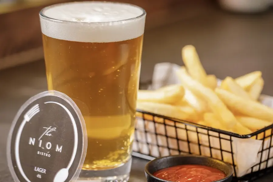 Basket of fries with house lager at Niom Bistro, Newtown