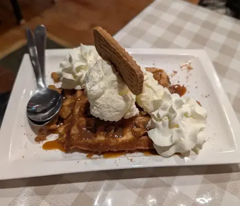 Waffle with whipped cream and caramel at Niom Bistro, Newtown